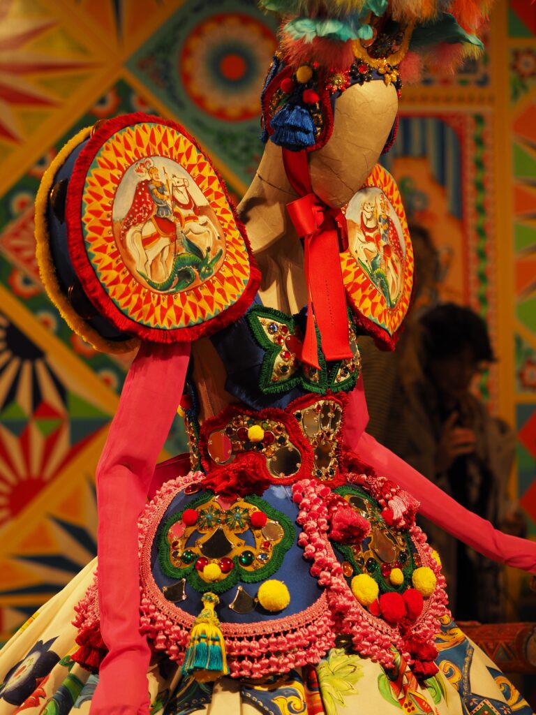 Dolce & Gabbana haute couture dress with intricate floral embroidery displayed at the Grand Palais exhibition.