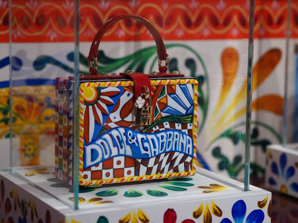 Close-up of a Dolce & Gabbana bag with elegant enamel detailing, part of the Grand Palais exhibition.