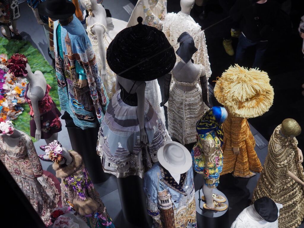 Themed room at Dolce & Gabbana’s Du Cœur à la Main exhibition, featuring ornate fashion pieces and artistic decor.