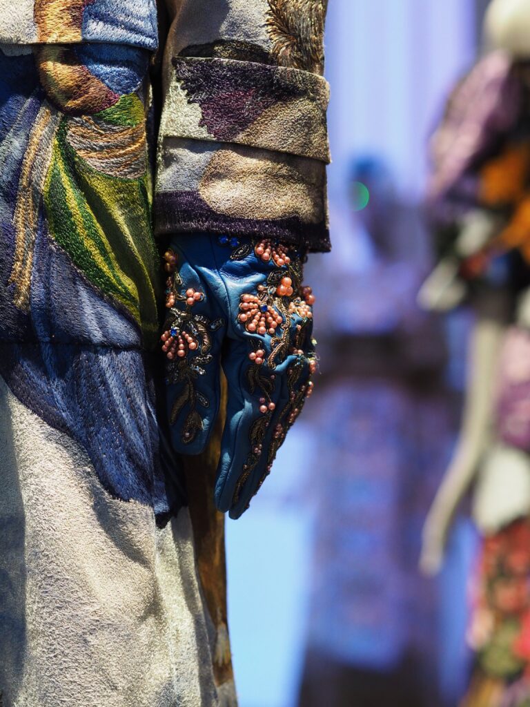 Close-up of a Dolce & Gabbana glove with elegant embroidery detailing, part of the Grand Palais exhibition.